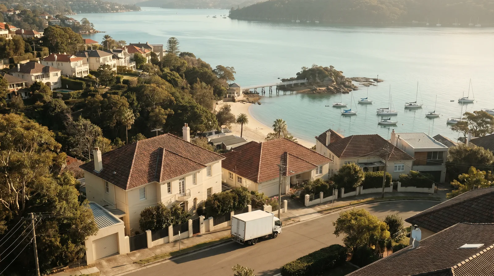 Terracotta rooftops stepping down the Balmoral hillside to Middle Harbour at 7am